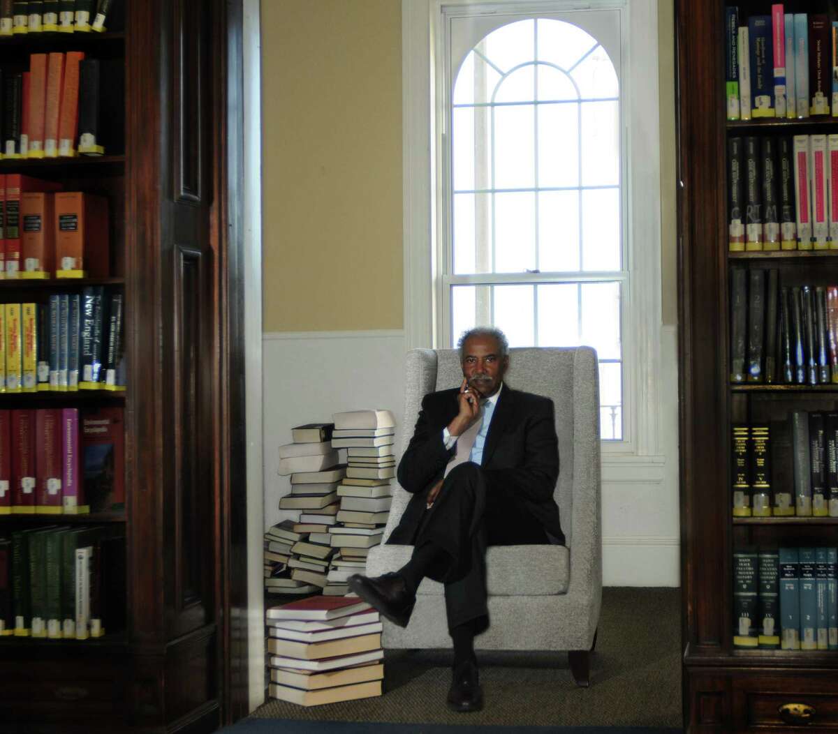 NEW HAVEN_Professor Norman Davis, of Albertus Magnus College, in the school library. Davis has written a book called "The Black Quarterback Syndrome:How to Succeed As a First or Pioneer in an Organization." Melanie Stengel/Register