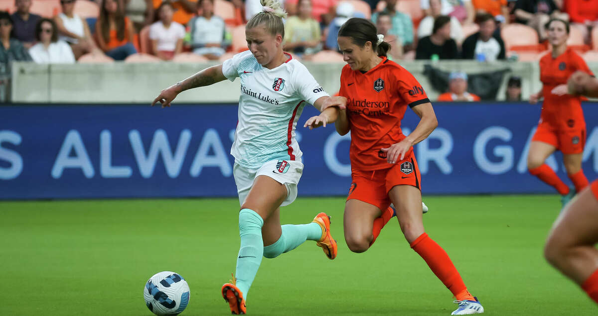 HOUSTON, TX JULY 1: Houston Dash midfielder Shea Groom (10) challenges Kansas City Current defender Hailie Mace(4) for the ball in the first half during the NWSL soccer match between the Kansas City Current and Houston Dash at PNC Stadium in Houston,Texas.