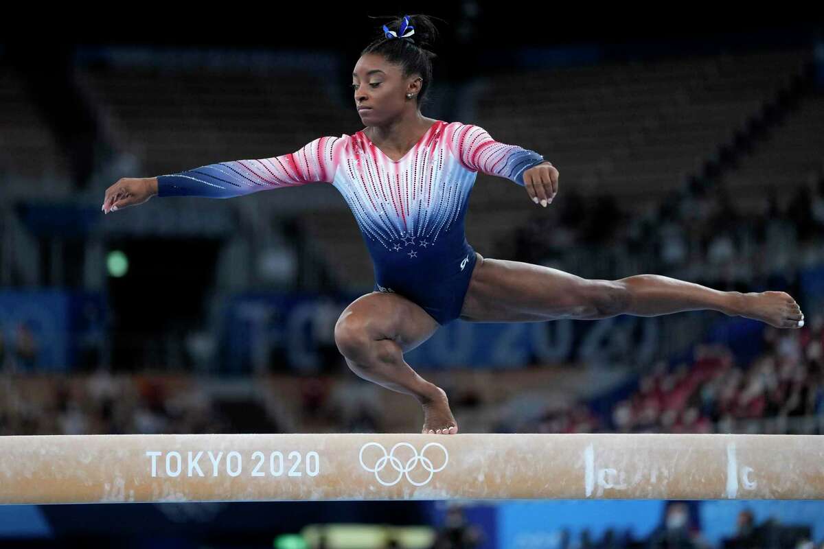 FILE - Simone Biles, of the United States, performs on the balance beam during the artistic gymnastics women's apparatus final at the 2020 Summer Olympics, Tuesday, Aug. 3, 2021, in Tokyo, Japan. Biles’ 2021 experiences, and how she talked about them, helped drive a robust conversation about athletes’ emotional health. (AP Photo/Ashley Landis, File)
