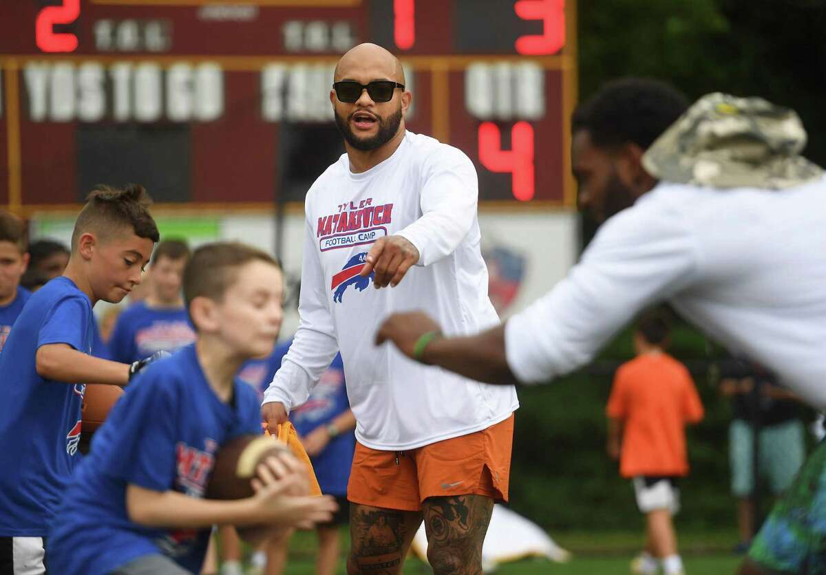 NFL players, including fullback Roosevelt Nix, left, work on drills with area youth at Buffalo Bills linebacker and former St. Joseph High School standout Tyler Matakevich’s camp in Trumbull on Saturday.
