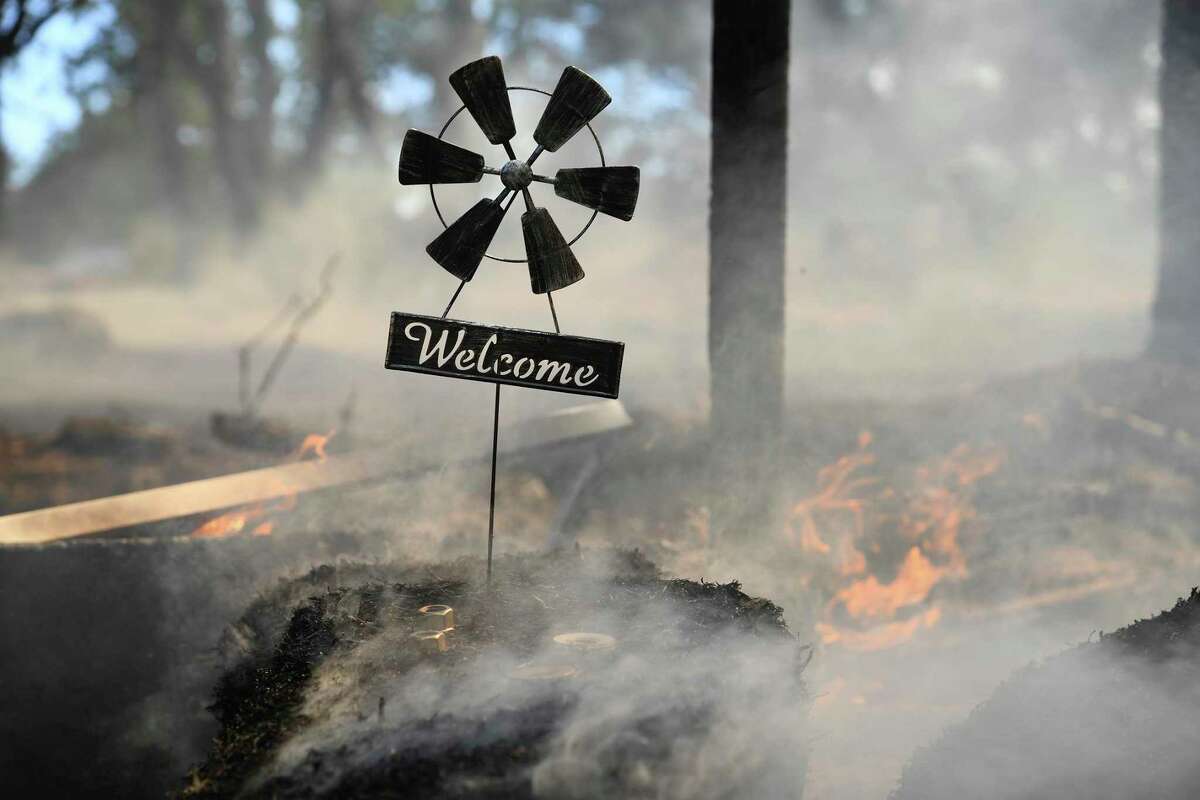 A welcome home sign sits at the front gate of a home along Troost Trail, that was saved by firefighters from the Rices Fire on Tuesday, June 28, 2022, in California's Nevada County. Containment of the fire was at 45% on Sunday, July 3.