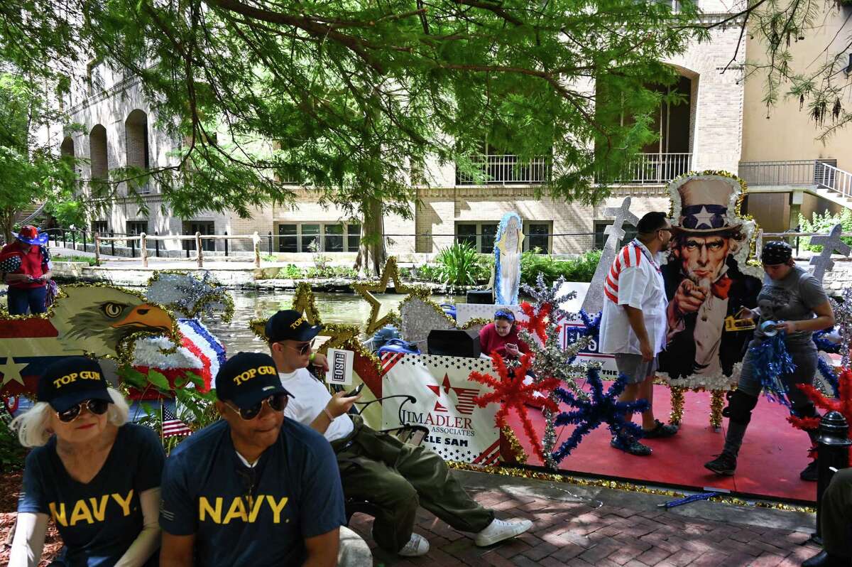 Last-minute decorations are added to a float before the start of the Armed Forces River Parade on Saturday, July 2, 2022.