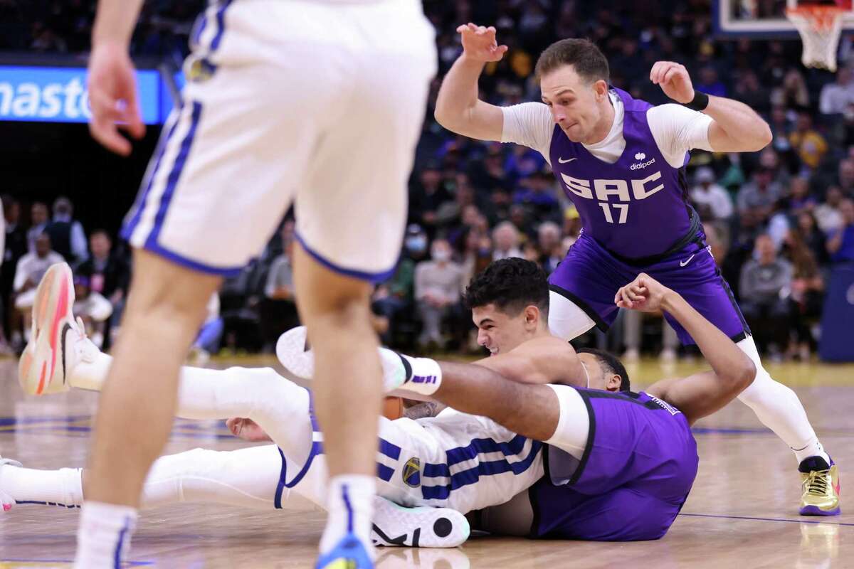 Golden State Warriors’ Gui Santos battles for a loose ball against Sacramento Kings’ Keegan Murray and Frankie Ferrari in 1st quarter during California Classic at Chase Center in San Francisco, Calif., on Saturday, July 2, 2022.