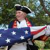 Arthur Byram with the Texas Sons of the American Revolution helps present the American flag during Conroe’s annual Stars and Stripes Celebration at Heritage Place Park, Saturday, July 2, 2022, in Conroe.