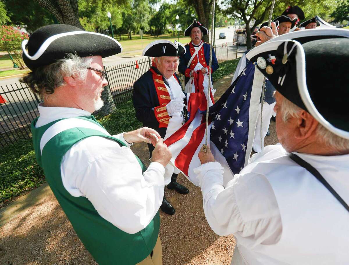 Arthur Byram, center, with the Texas Sons of the American Revolution helps Don Hayes, left, and David Hammier present the American flag during Conroe’s annual Stars and Stripes Celebration at Heritage Place Park, Saturday, July 2, 2022, in Conroe.