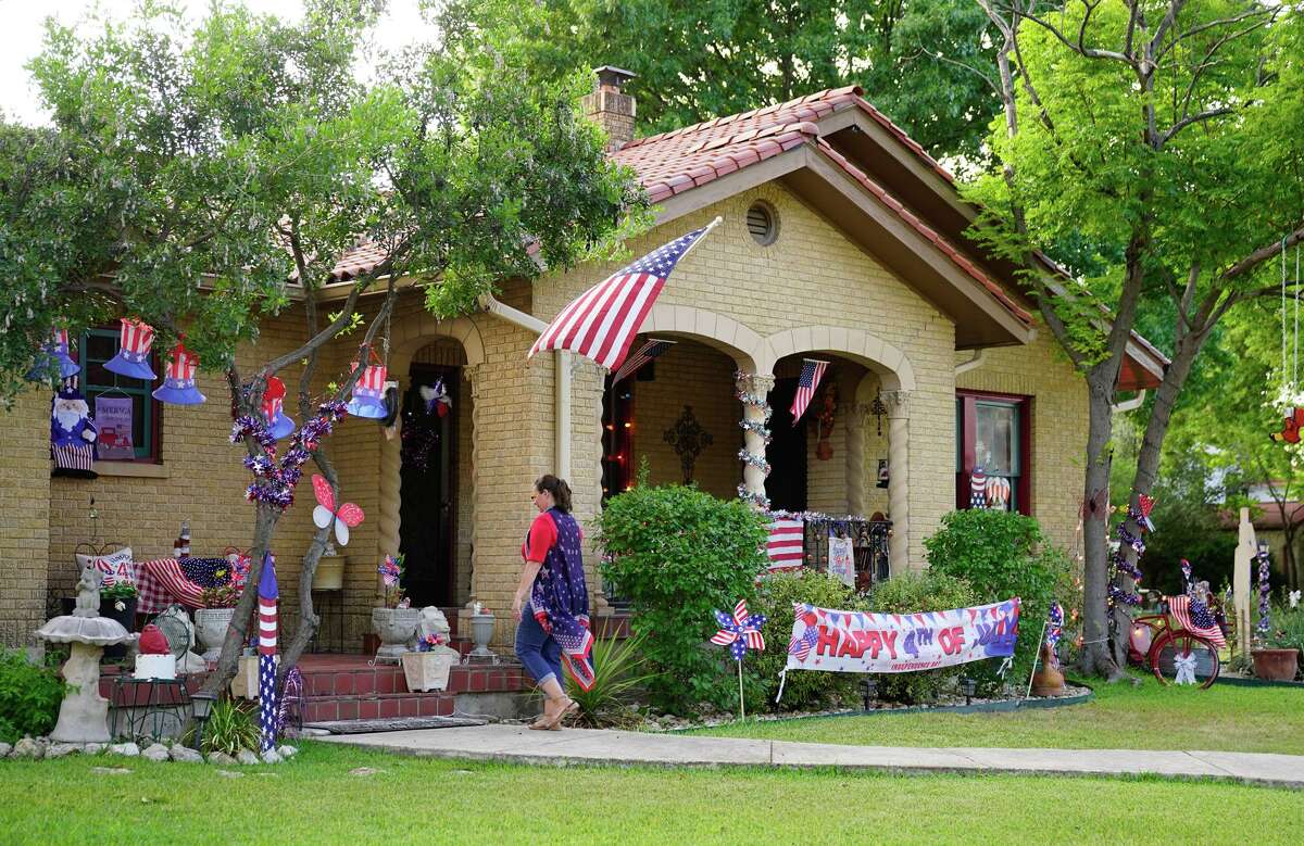 Annie Ramirez walks in front of her home, which is decorated for the Fourth of July. Ramirez decorates for every holiday, including Fiesta.