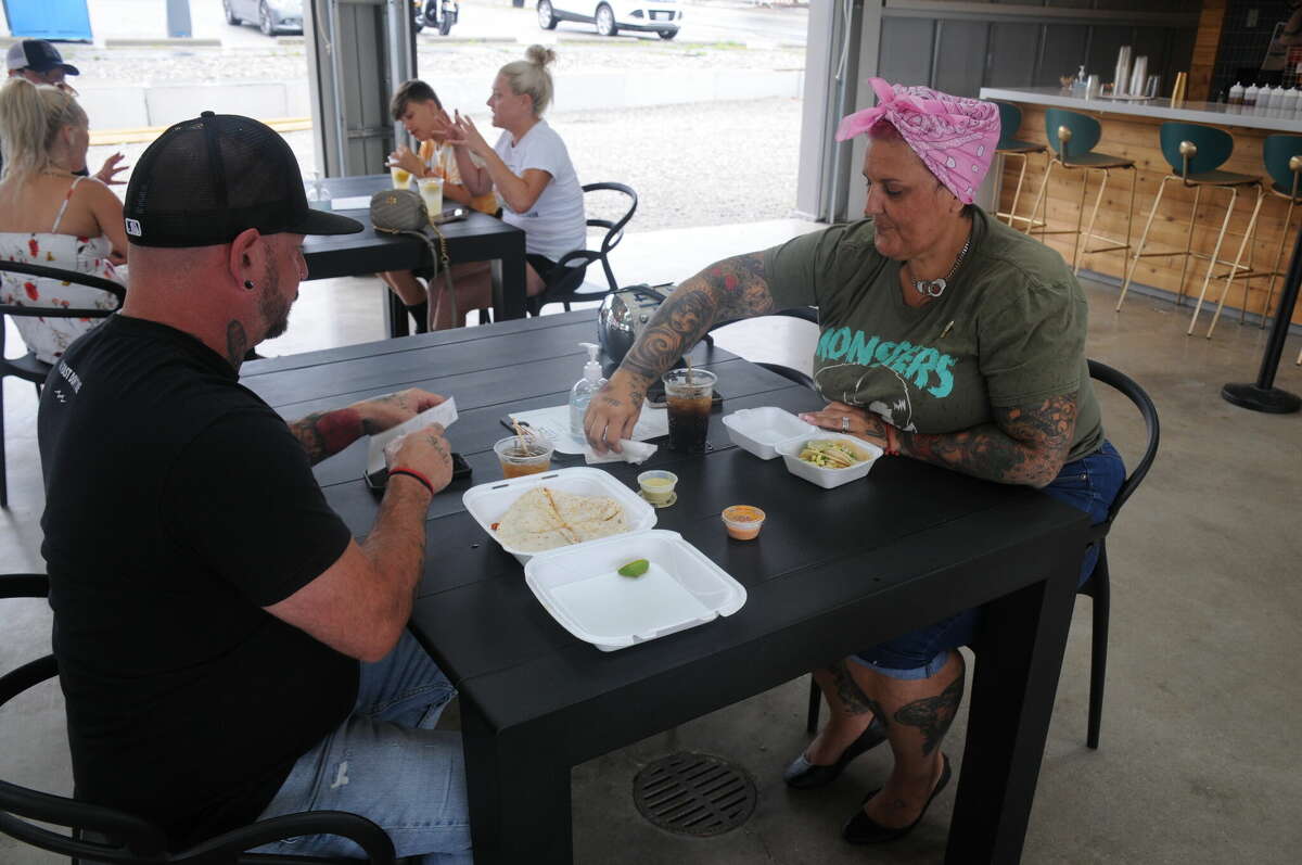 Dominik and Michelle Rulo of Wood River enjoy a meal at the Flock Food Truck Park in Alton on Saturday.