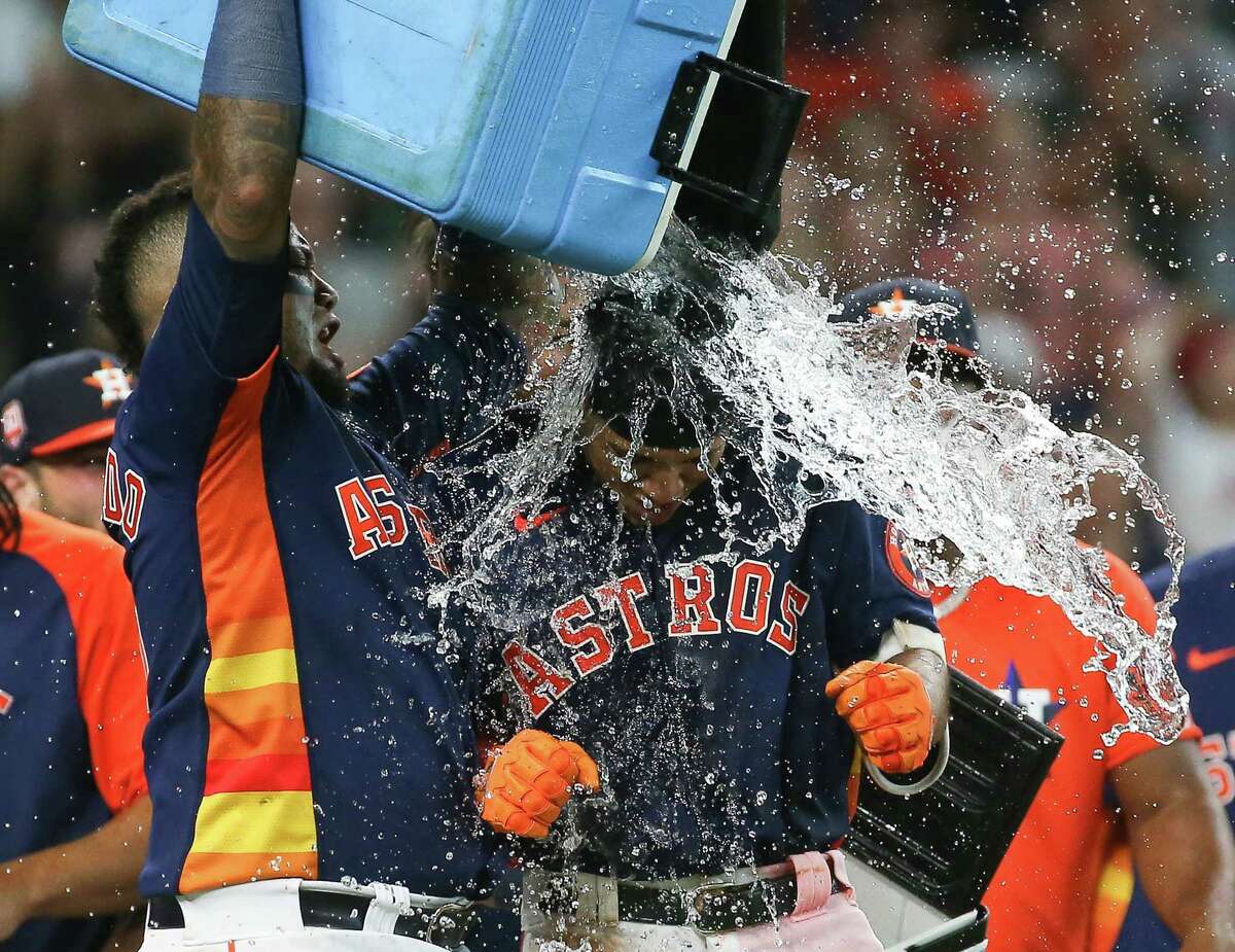 Houston Astros catcher Martin Maldonado, left, dumps water on Jeremy Peña to celebrate Peña’s walk-off home run during the bottom ninth inning of an MLB game against the Los Angeles Angels Sunday, July 3, 2022, at Minute Maid Park in Houston. Houston Astros defeated Los Angeles Angels 4-2.