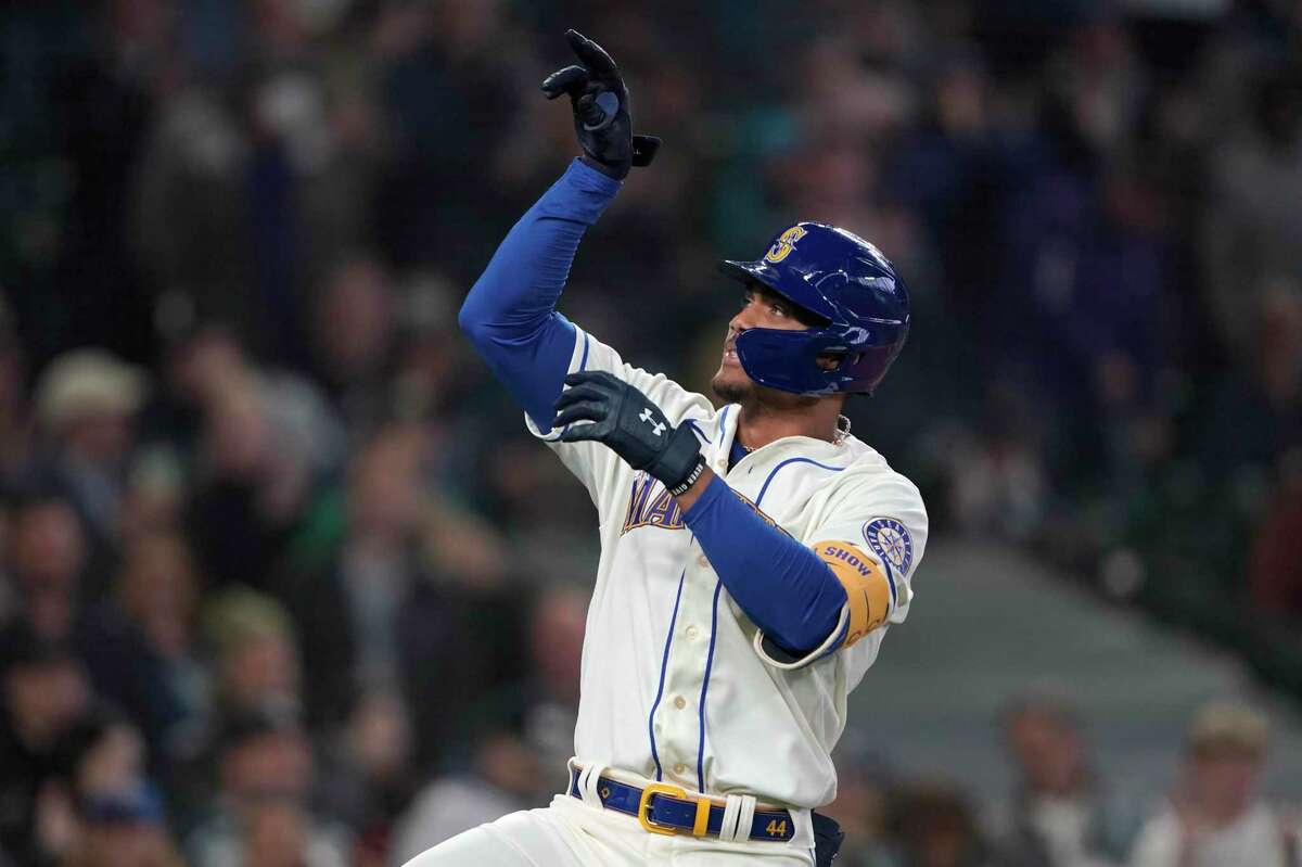 Seattle Mariners' Julio Rodriguez gestures after crossing the plate after he hit a solo home run against the Oakland Athletics during the first inning of a baseball game, Sunday, July 3, 2022, in Seattle. (AP Photo/Ted S. Warren)