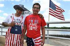 Greg Moreno (left) and Thomas Zurita sport patriotic colors at Woodlawn Lake, celebrating Independence Day with family and friends on Monday. The hot summer temperature did not deter San Antonians as they claimed their favorite spots to grill hamburgers and await the evening fireworks show.