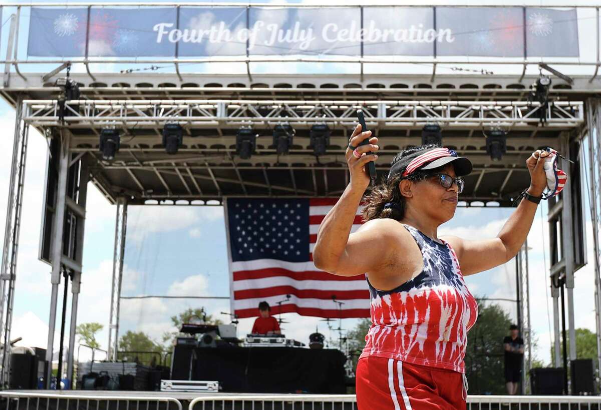 Alva Stevens moves to the music as people gather at Woodlawn Lake to celebrate Independence Day with family and friends on Monday. Even after doing a two-hour Zumba session at the event, Stevens had to dance some more.