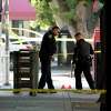 Sacramento police look over evidence markers near the scene of a fatal downtown shooting near the state Capitol building.