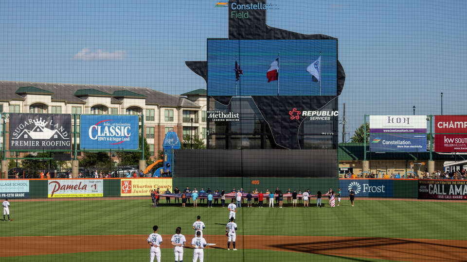 Sugar Land Space Cowboys starting pitcher Forrest Whitley #29 and teammates listen to the national Anthem before playing against the El Paso Chihuahuas at Constellation Field on July 4, 2022 in Sugar Land.
