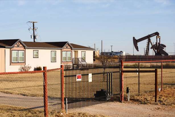 A pumpjack next to a home in Gardendale. Texas is the nation’s top natural gas producer but the state has started exporting more of it to other countries, which contributes to rising utility costs for Texans.