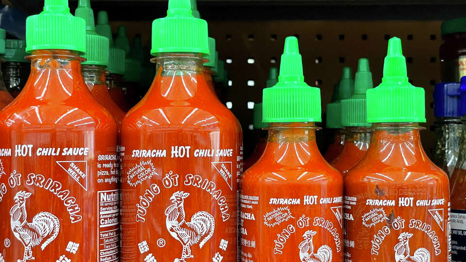 Bottles of Huy Fong Foods Sriracha sauce are displayed on a supermarket shelf on June 10, 2022 in Larkspur, California. Due to a shortage of the chili peppers used to make Sriracha hot sauce, the popular condiment is becoming hard to find on store shelves. Huy Fong Foods announced that it will temporarily suspend production and will be unable to fill orders placed after mid-April.