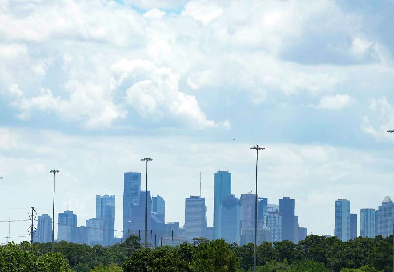 Trees from Memorial Park buffer the view of Houston's skyline on a hazy hot day on Monday, July 4, 2022 in Houustonn. Hot weather exacerbates ozone, an air pollutant that's harmful to asthmatics.