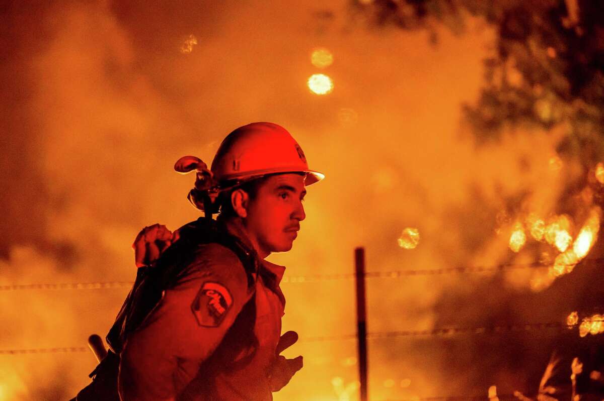 Firefighter Rafael Soto battles the Electra Fire burning in the Rich Gulch community of Calaveras County, Calif., on Tuesday, July 5, 2022. 