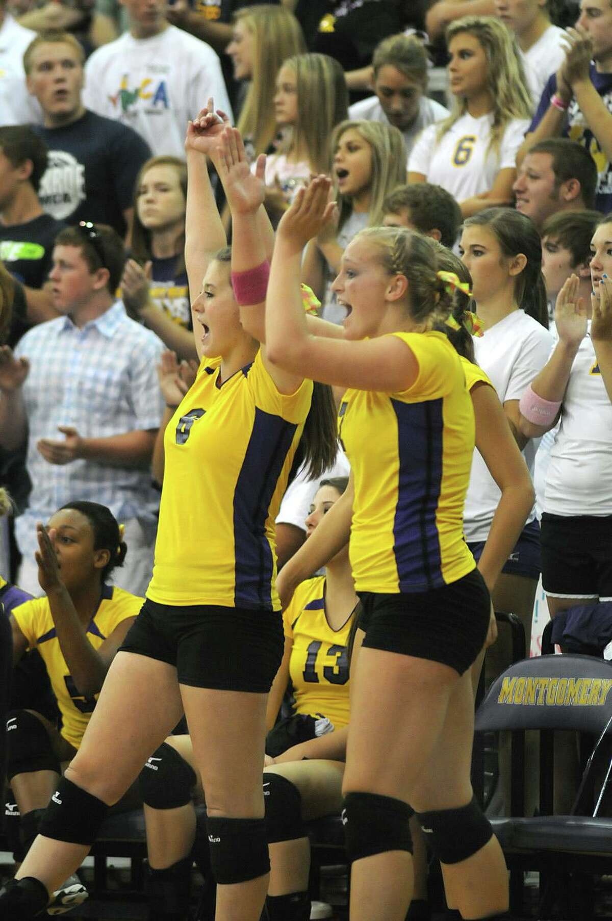 Montgomery senior outside hitter Jessica Allen, left, and senior middle blocker Stormi Champion celebrate a Lady Bear point during their match against Magnolia. Photo by Jerry Baker