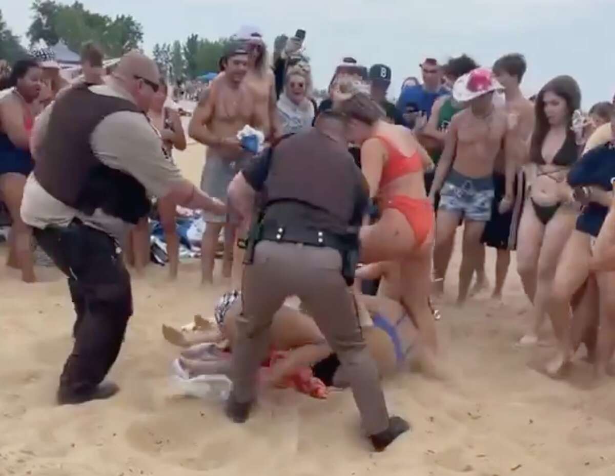 Members of the Huron County Sheriff's Office are shown breaking up a fight on the beach in Caseville Monday in this screen grab from a video courtesy of Ty McPherson.