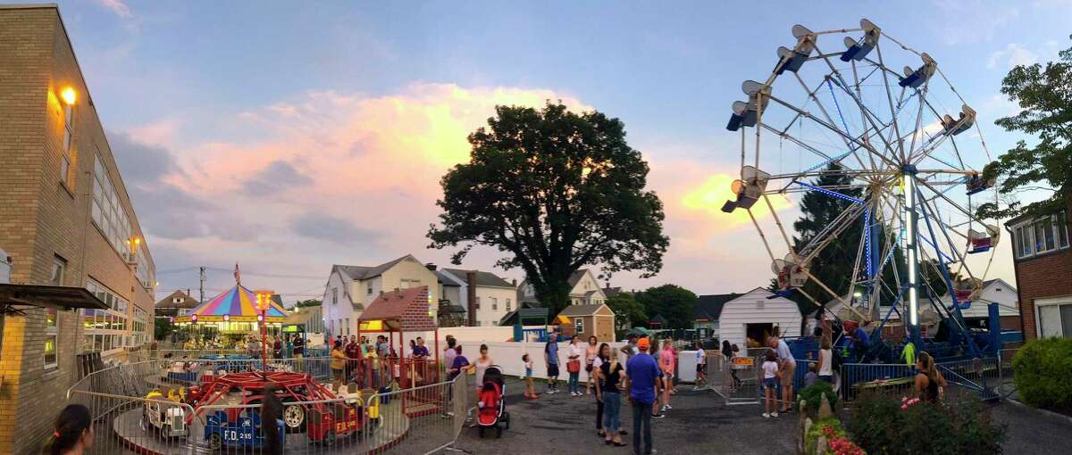 Residents enjoy the annual St. Roch's Feast in Greenwich, Connecticut on August 8, 2018. The event, a major fundraiser for the church, offers live music, food, games, rides and entertainment.