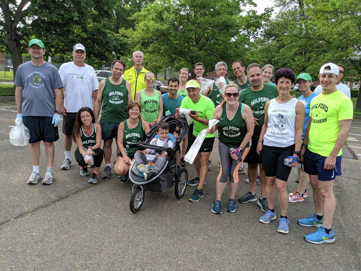 Milford Road Runners gather after a day of running and picking up trash in MIlford.