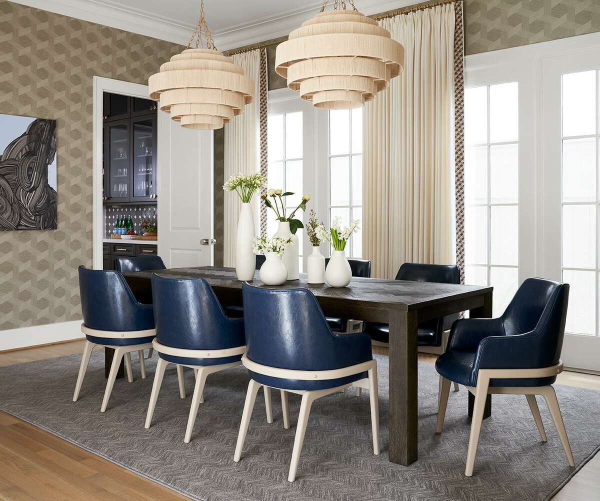 Beautiful Phillip Jeffries vinyl woven sisal wallpaper and chandeliers covered in natural fiber add texture in the dining room.