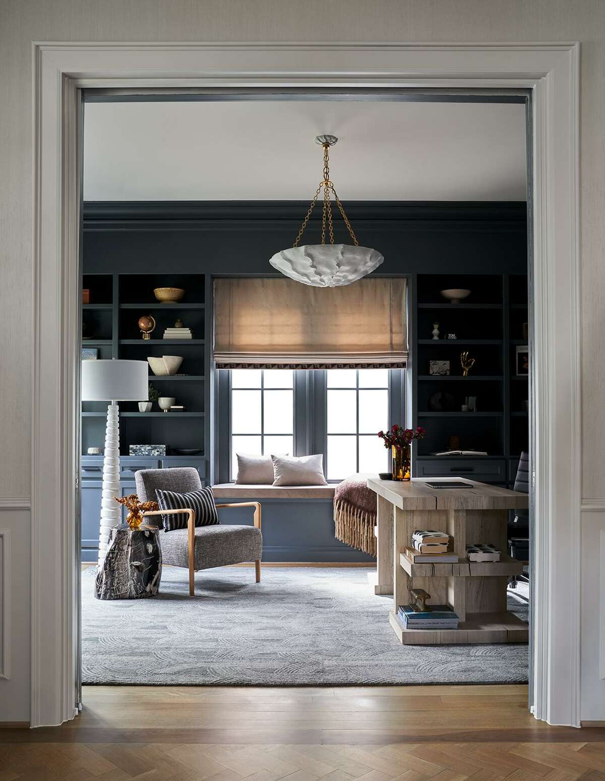 Walls and cabinets painted Sherwin-Williams “Web Gray” make a handsome backdrop for the furnishings in the home office.