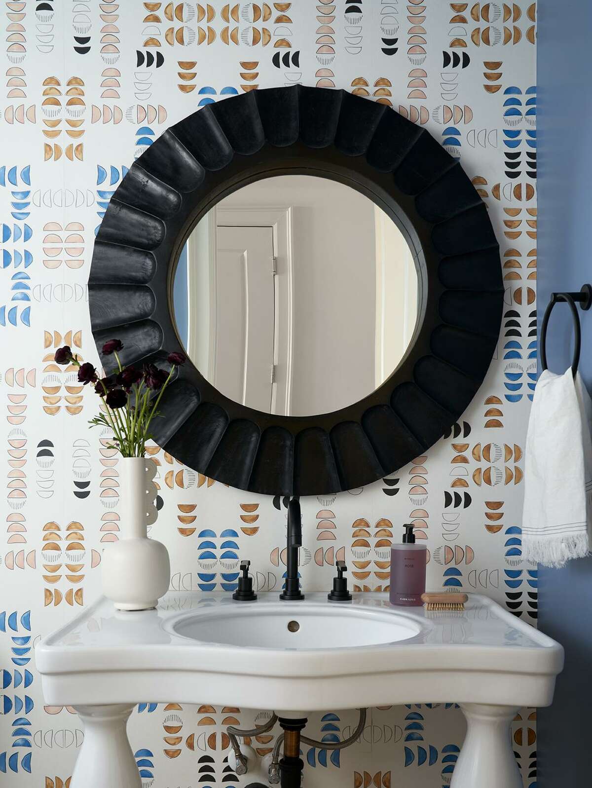 Plumbing fixtures in black matte were paired with a new, framed mirror in the powder bathroom.