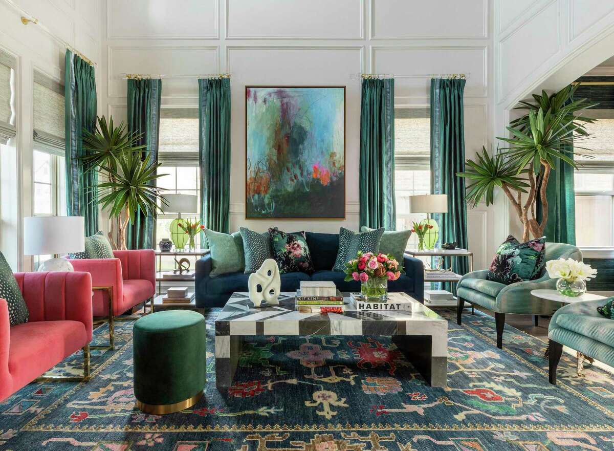 Millwork creates an architectural feature that runs up the walls of the living room, a space now saturated with color.