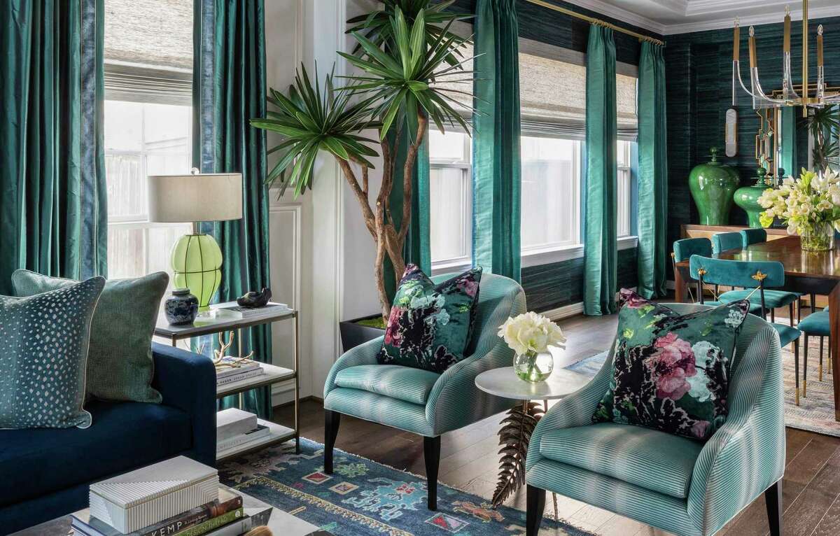 Teal appears in draperies, upholstery, and wall coverings in the living room and dining room.