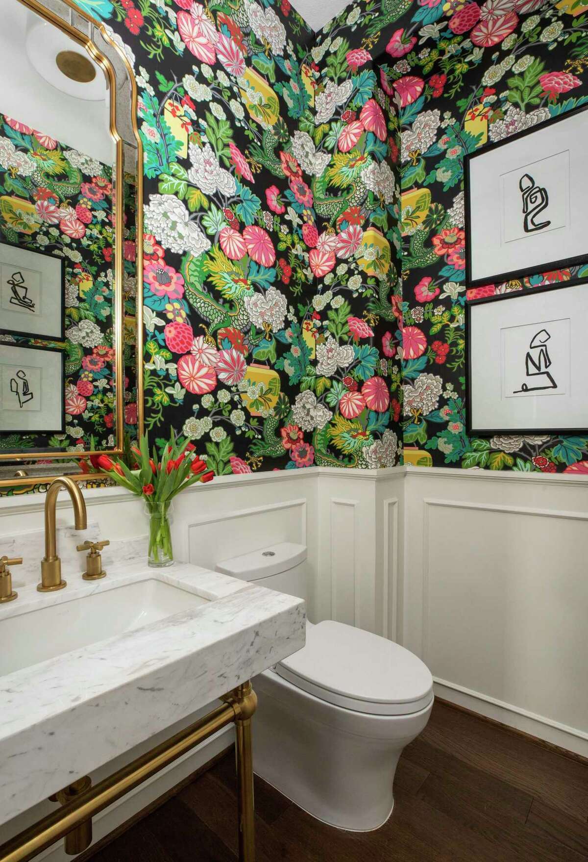 A plain powder bathroom got a lively makeover with paneling and wallpaper with a chinoiserie pattern.