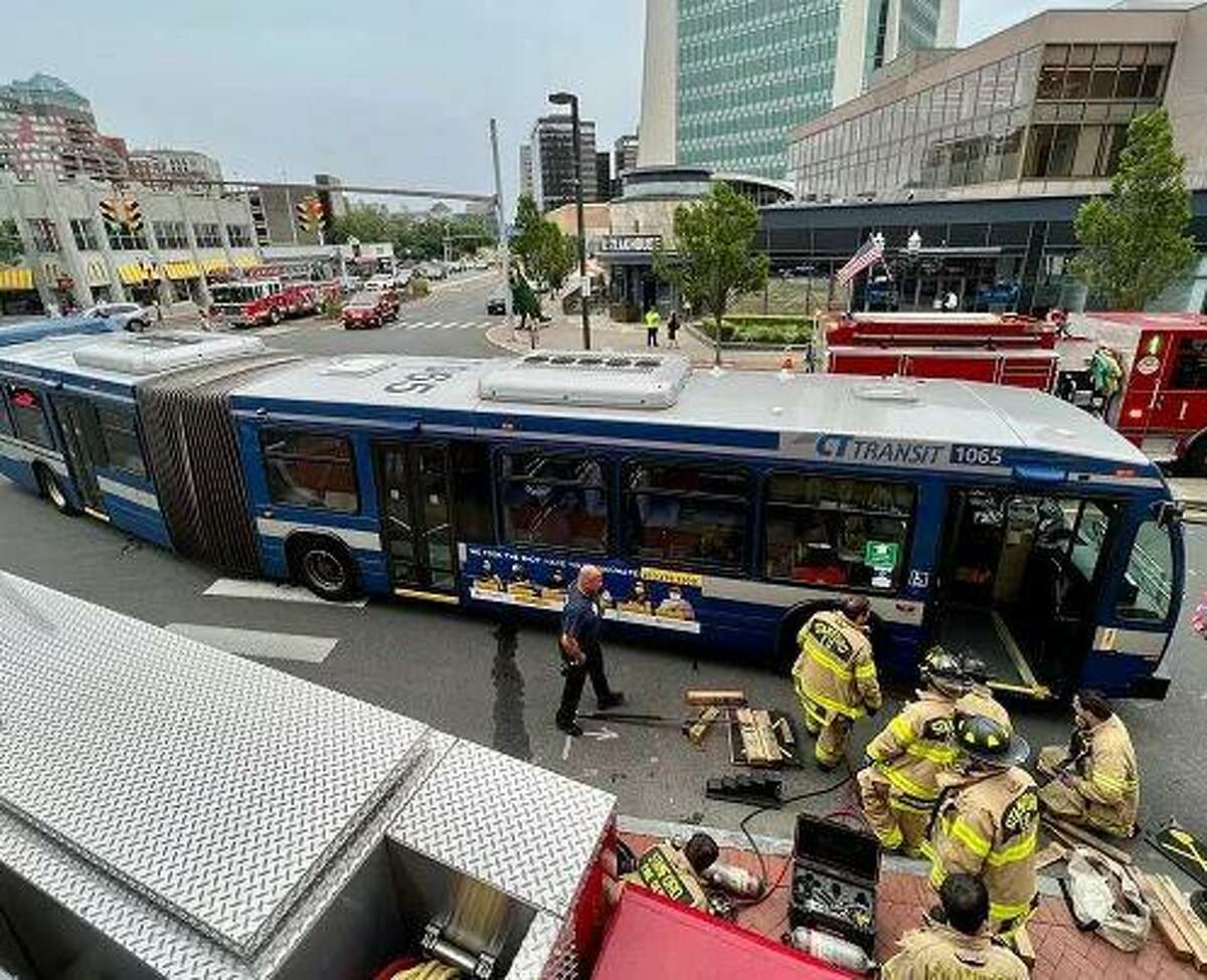 Stamford firefighters freed a woman from under a Connecticut Transit Bus at the intersection of Broad and Atlantic Streets Tuesday afternoon.