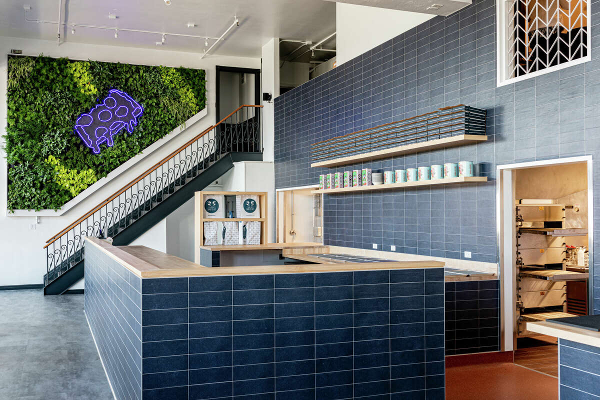 The new Square Pie Guys location features a living plant wall.