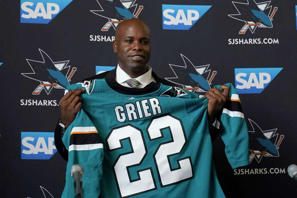 Mike Grier poses for photos as he is introduced as the new general manager of the San Jose Sharks at a news conference in San Jose, Calif., Tuesday, July 5, 2022. (AP Photo/Jeff Chiu)