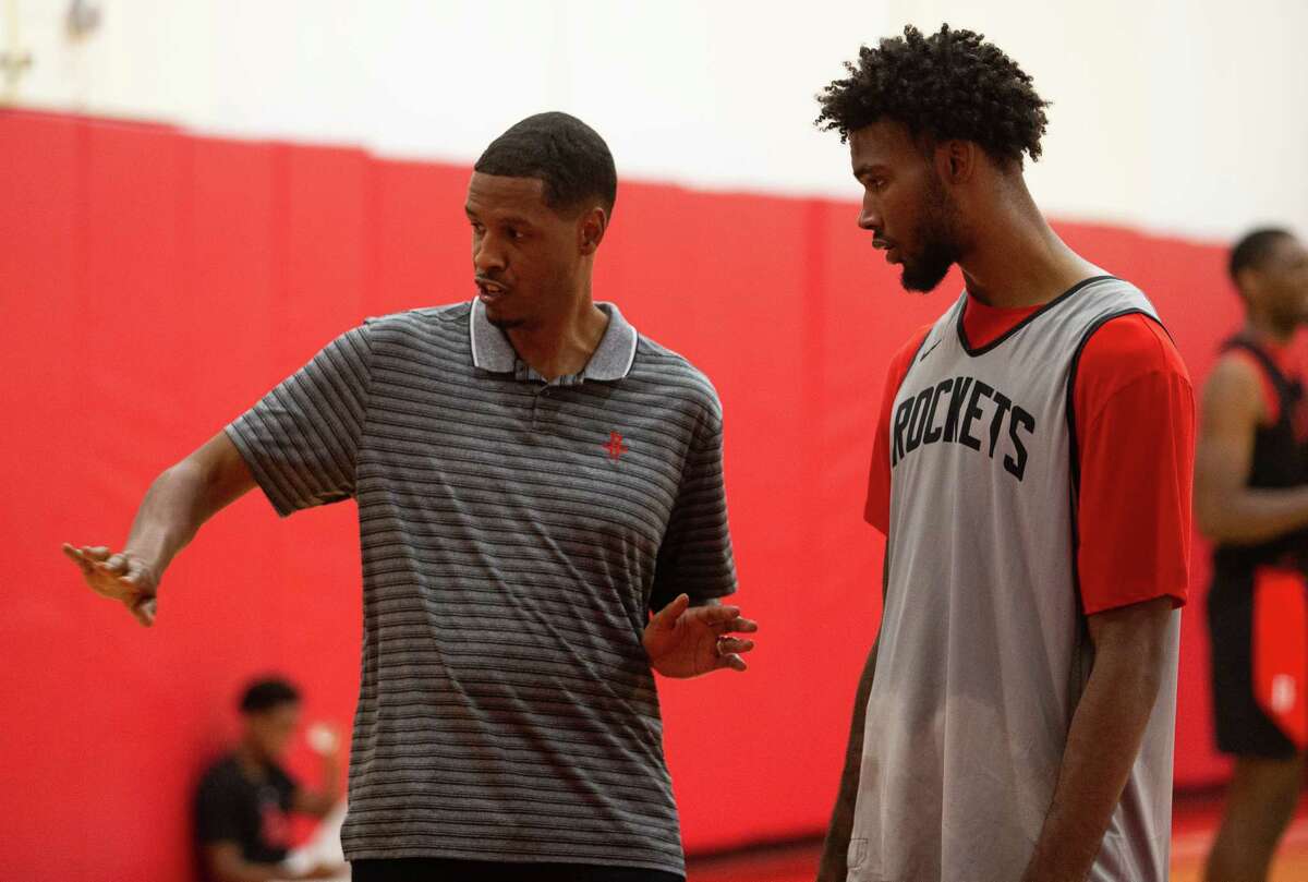 Stephen Silas talks with rookie Tari Eason after a summer league practice in July.