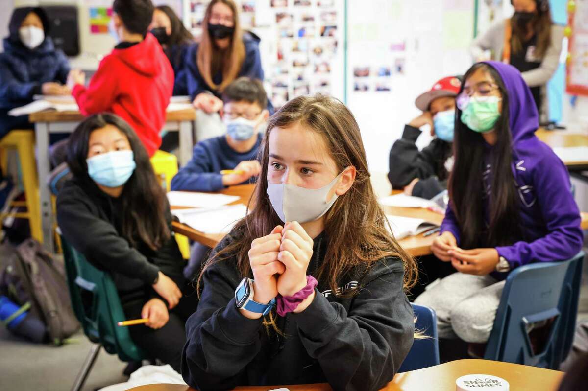 Zoe Campbell, 12, wears a mask in math class at Hoover Middle School in San Francisco. California will not require students and school staff members to wear masks in the coming school year.