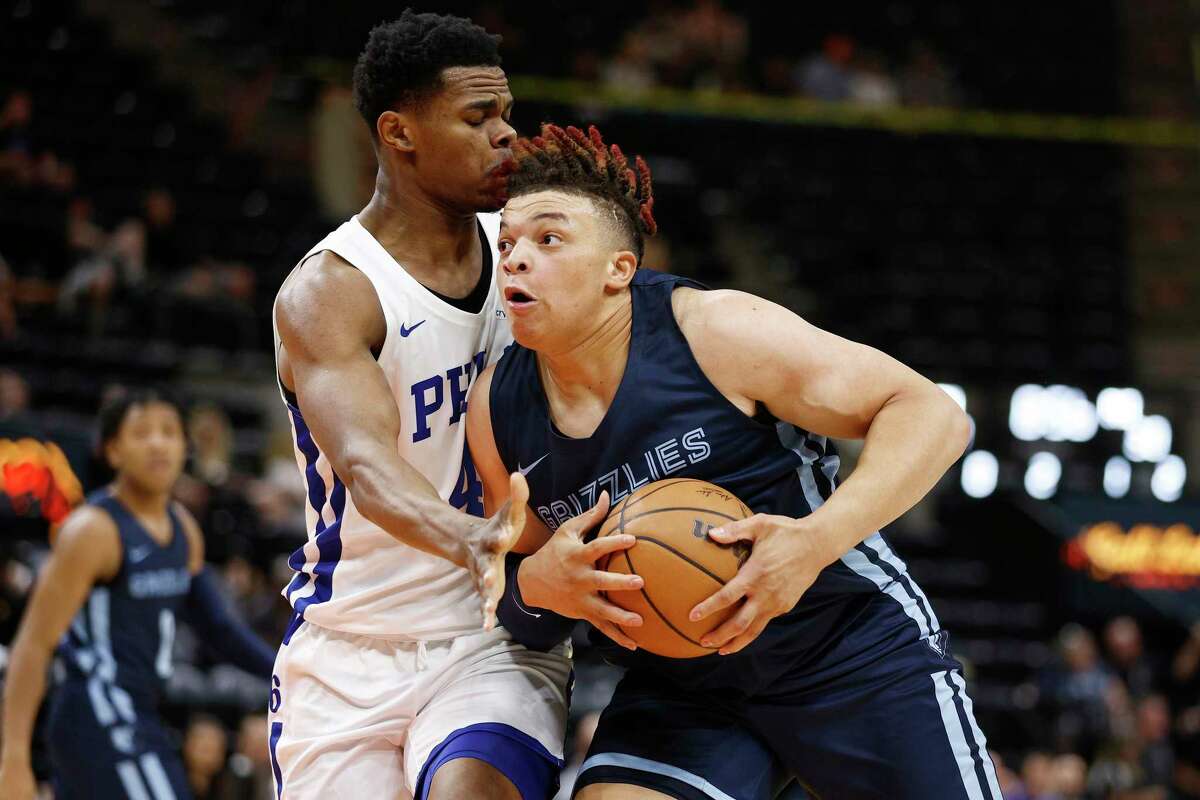 Memphis Grizzlies forward Kenny Lofton Jr., right, drives to the basket against Philadelphia 76ers forward Michael Foster Jr. during the first half of an NBA summer league basketball game Tuesday, July 5, 2022, in Salt Lake City. (AP Photo/Jeff Swinger)
