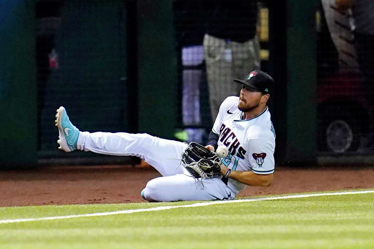 Arizona Diamondbacks left fielder Cooper Hummel is unable to make the catch on an RBI single by San Francisco Giants' Austin Wynns during the seventh inning of a baseball game Tuesday, July 5, 2022, in Phoenix. (AP Photo/Ross D. Franklin)