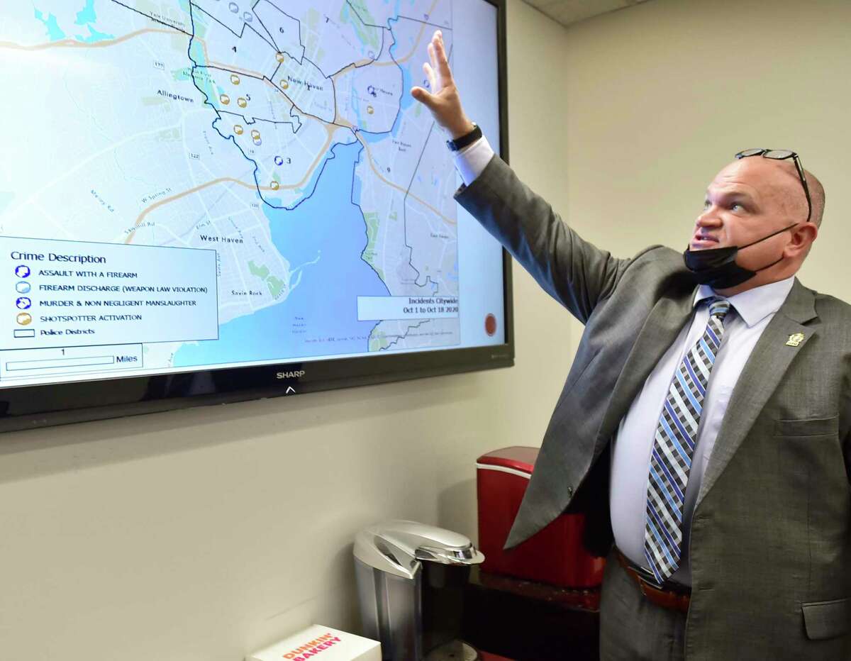 New Haven police Assistant Chief Karl Jacobson looks at a citywide map that pinpoints different incidents and descriptions of crime in the NHPD Elm City Intel Center that traces the movement of crime with guns and its dedicated criminal intelligence gun tracing team, in Octover 2020.