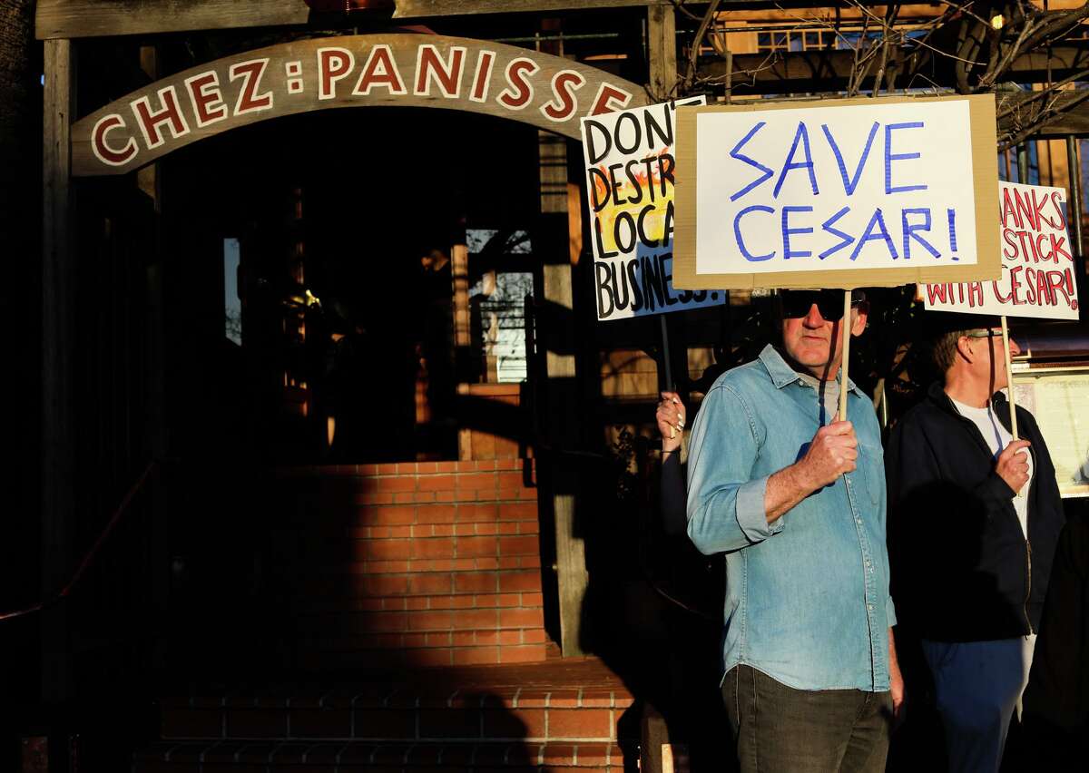Cesar general manager Jim Mellgren stands with protesters outside Chez Panisse on Tuesday, March 8, 2022, in Berkeley.