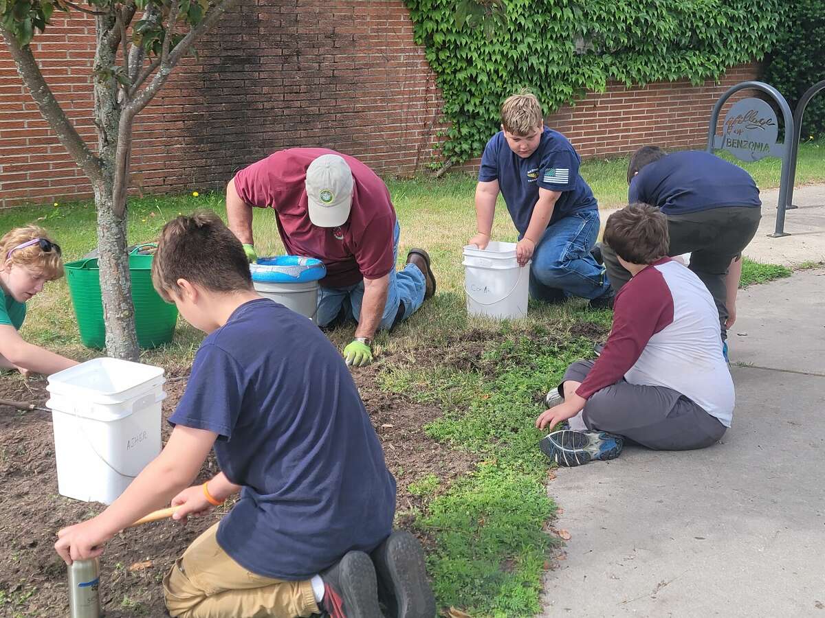 Benzie County Central Middle School students help take care of the public gardens in Benzonia as part of an ECO SEEDS summer prgram.