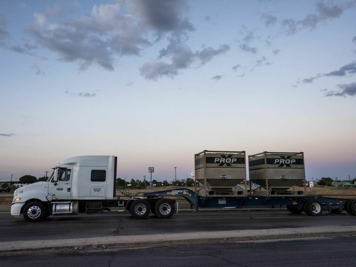 A truck hauling fracking sand containers makes its way onto the interstate highway in Big Spring. Photographer: Matthew Busch/Bloomberg