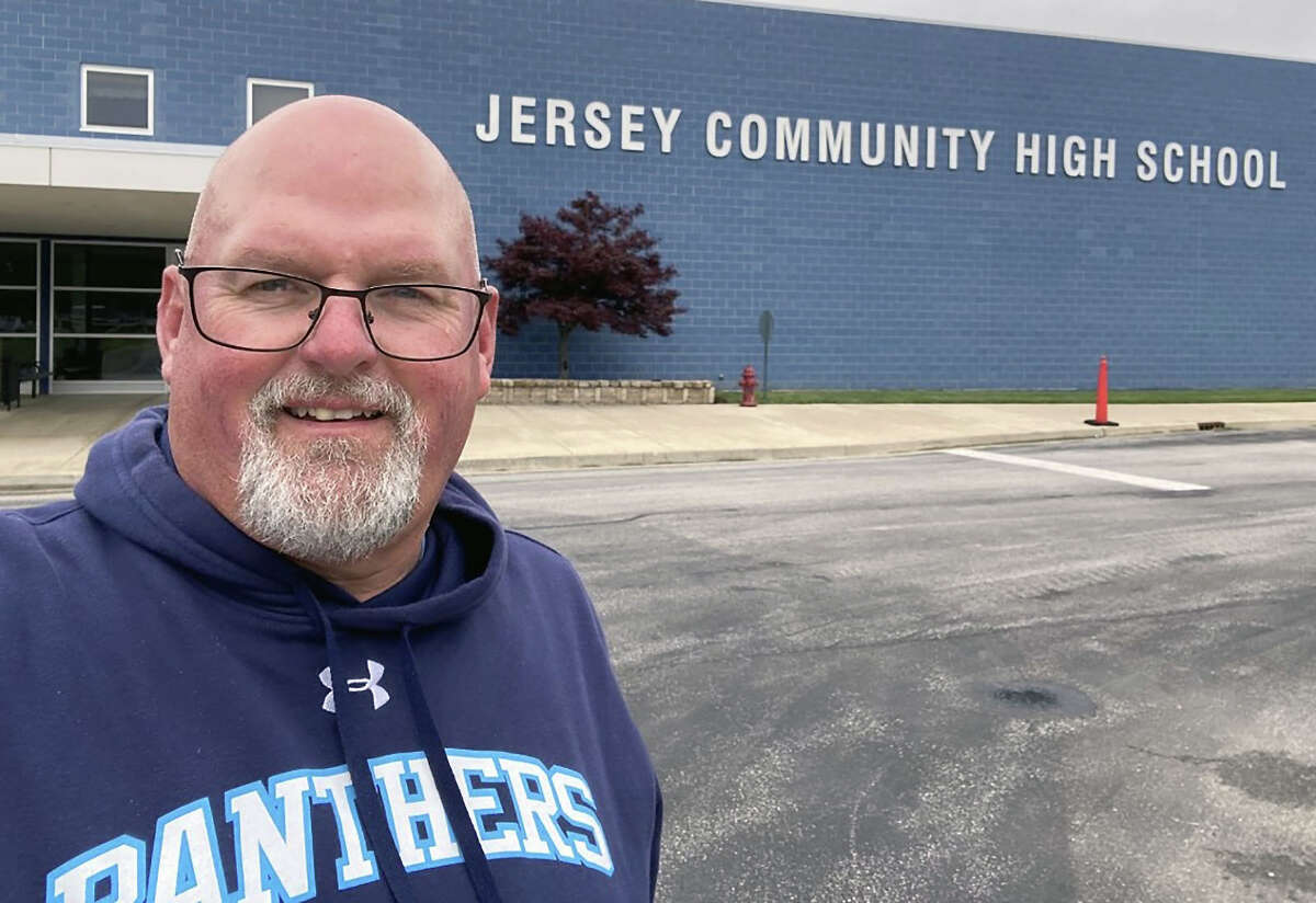 Chris Skinner poses in front of Jersey High School on his last day as a teacher/coach. Skinner has retired after 34 years. During his time there, Skinner taught history and econmics and coached football, baseball, bowling, tennis, wrestling and softball