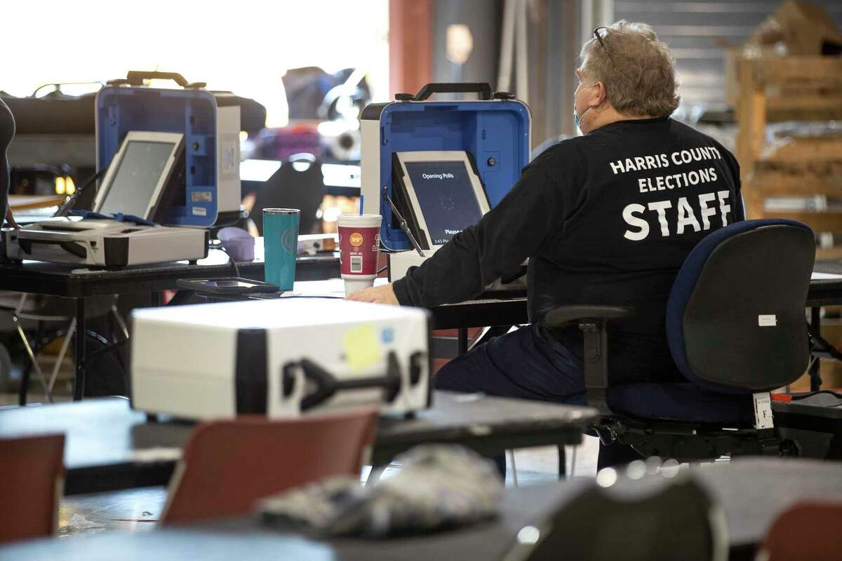 A Harris County election staffer prepares to run a report on a voting scanner after it came into the Harris County Election Technology Center Wednesday, March 2, 2022 in Houston.