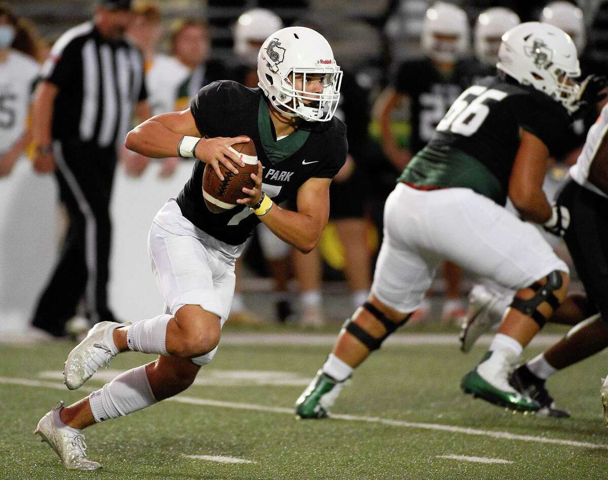 Kingwood Park quarterback Hayden Bender scrambles during the first half of a high school football game against Texas City, Thursday, Sept. 30, 2021, in Humble.