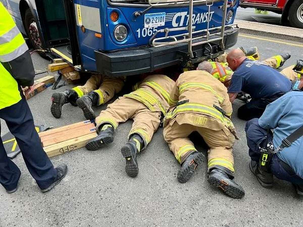 Stamford firefighters freed a woman from under a Connecticut Transit Bus at the intersection of Broad and Atlantic Streets on Tuesday, July 5.