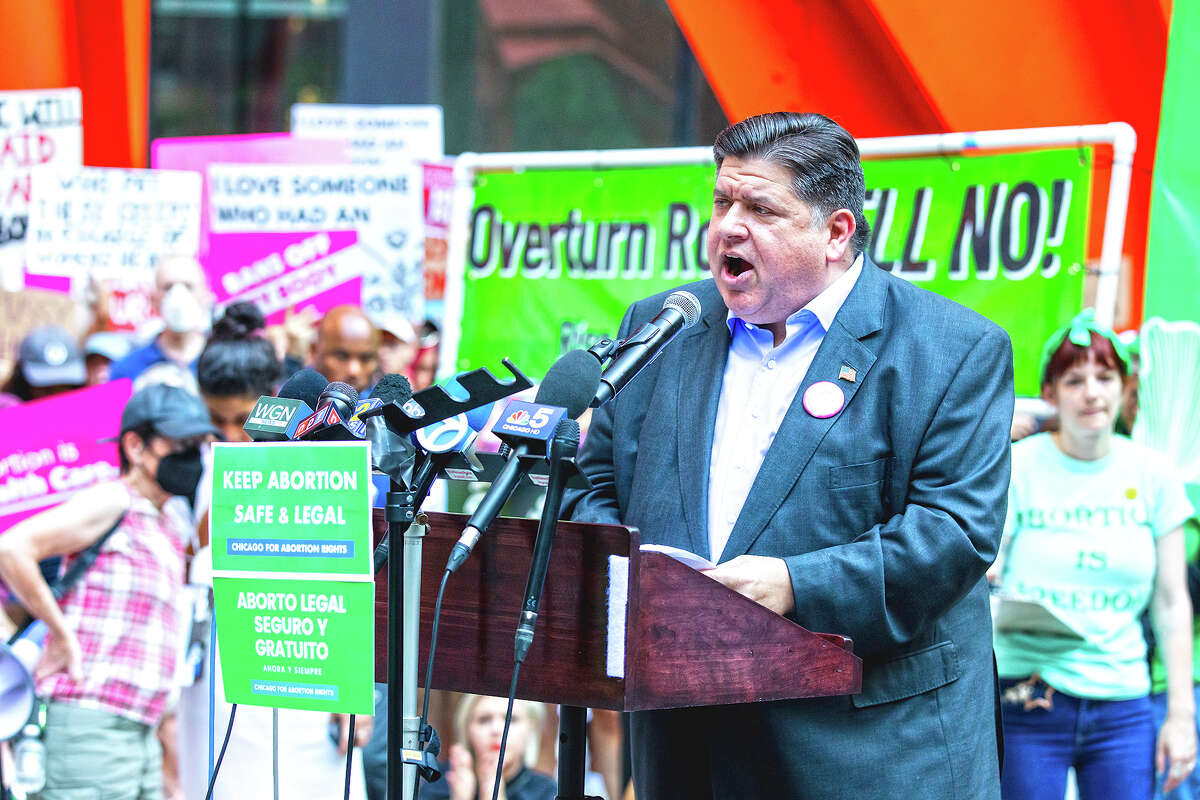 Gov. J.B. Pritzker speaks to a crowd at an abortion rights rally. Pritzker and top Democratic leaders say that while they still plan to call a special session this year to strengthen abortion rights, they expect to take the “remainder of the summer” to craft policies.