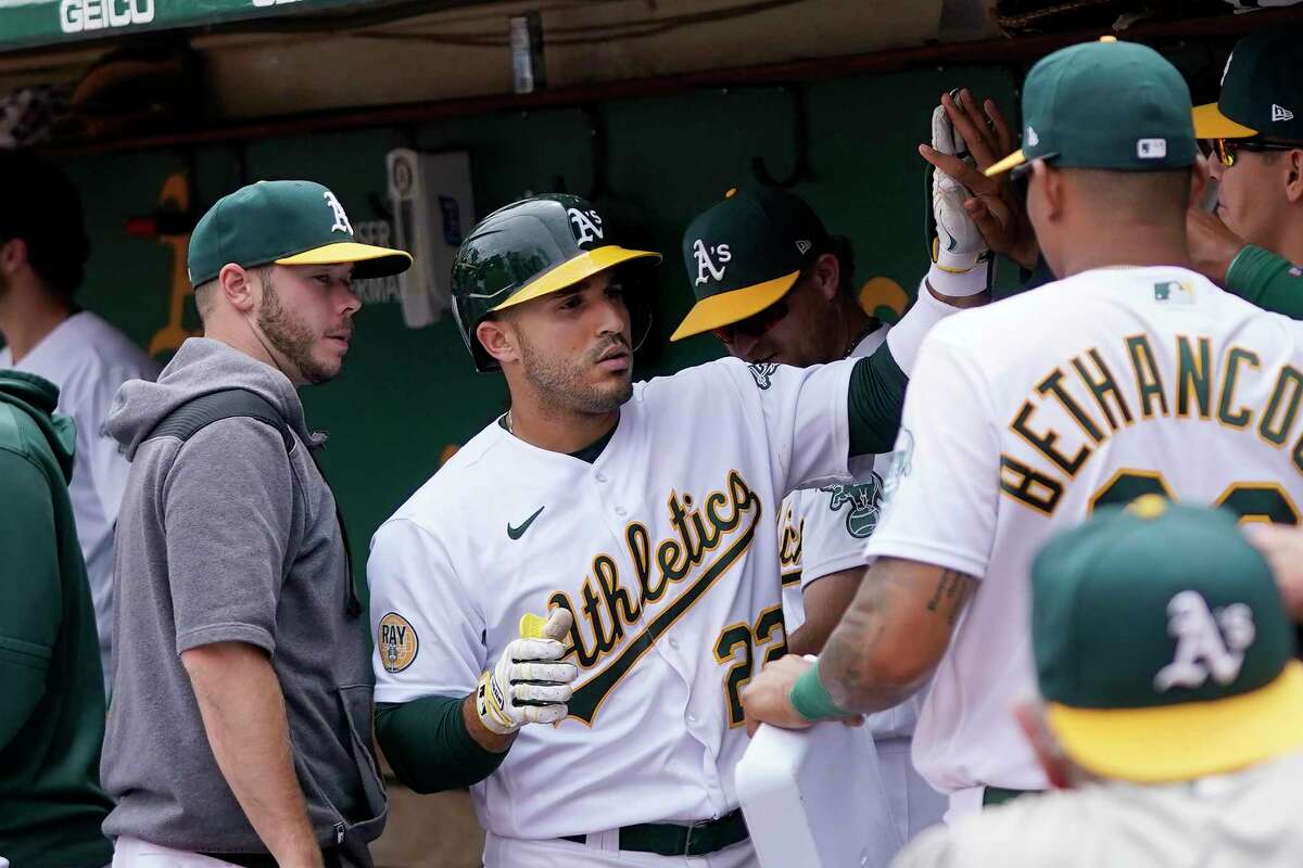 Oakland Athletics' Ramon Laureano, middle, is congratulated by teammates after hitting a home run against the Toronto Blue Jays during the sixth inning of a baseball game in Oakland, Calif., Wednesday, July 6, 2022. (AP Photo/Jeff Chiu)