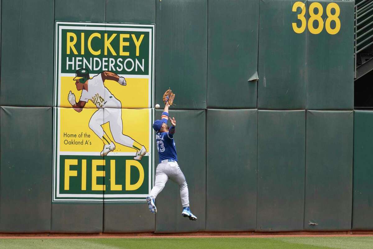 Toronto Blue Jays’ Lourdes Gurriel Jr. misses a fly ball hit by Oakland Athletics' Elvis Andrus during the second inning of a MLB baseball game in Oakland, Calif. Wednesday, July 6, 2022.