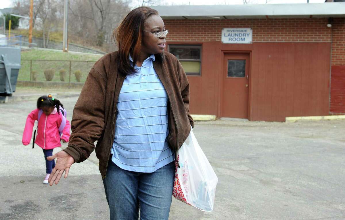 Malika Mosley, with daughter Maqila Mosley-Williams, laments the lack of a laundry facility at the Riverside apartment complex in Ansonia, Conn. on Thursday, April 7, 2011.